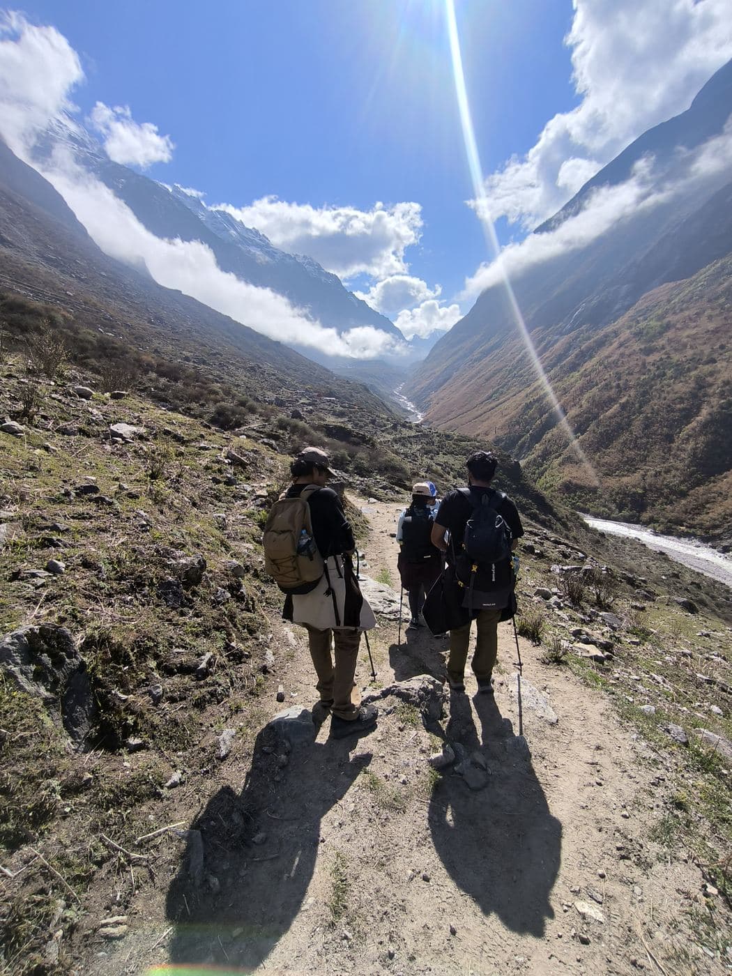 Trekkers and their guide walking up the Langtang valley trail