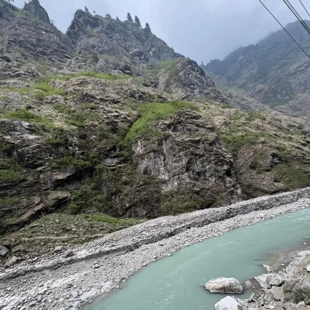 Green blue Marsyangdi river flowing among high hills in Manang