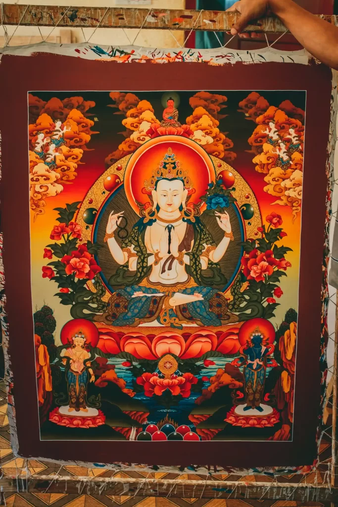 Intricate Thangka painting with detailed Buddhist motifs and sacred symbols