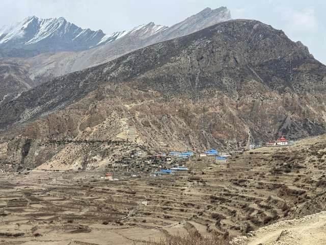 Nar Village in the Nar village and traditional settlement layout with rugged topography and towering highlands on the northwest side.