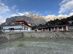 Peaceful Thrang Choephel Ling Monastery in the Nar Phu Valley, Nepal, with Pisang Peak visible in the background.