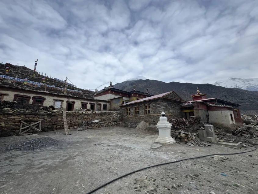 Tashi Lhakhang Monastery with its traditional old building and colorful Buddhist prayer flags fluttering in the wind, Nar Phu Valley