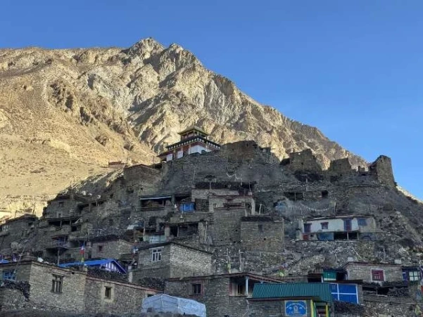 Morning view of Phu Village in Manang, Nepal, surrounded by traditional stone houses and mountain scenery.